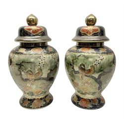 Pair of Chinese Satsuma baluster shaped lidded vases, decorated with birds perched amongst peonies, H36cm 