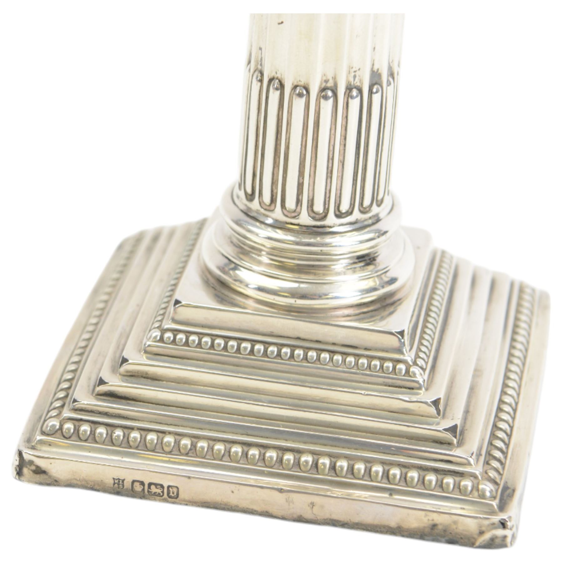 Pair of early 20th century silver Corinthian column candlesticks, upon square stepped filled bases, hallmarked Walter Latham & Son, Sheffield 1913, H16cm