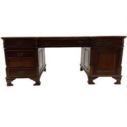 Georgian style hardwood partner's desk, the shaped top with three sectional leather insets, fitted with drawers and cupboards, on bracket feet