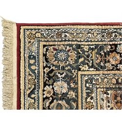 Persian design rug, rectangular crimson ground field with medallion, surrounded by trailing foliate branches, within wide border bands decorated with stylised floral motifs 