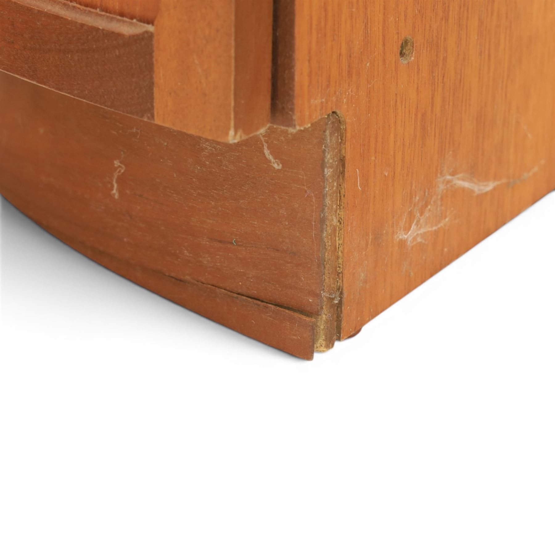 Nathan - teak corner cabinet, the upper section with moulded cornice and two fixed shaped open shelves, above a curved corner cupboard with twin signature square panelled doors, on a shaped plinth