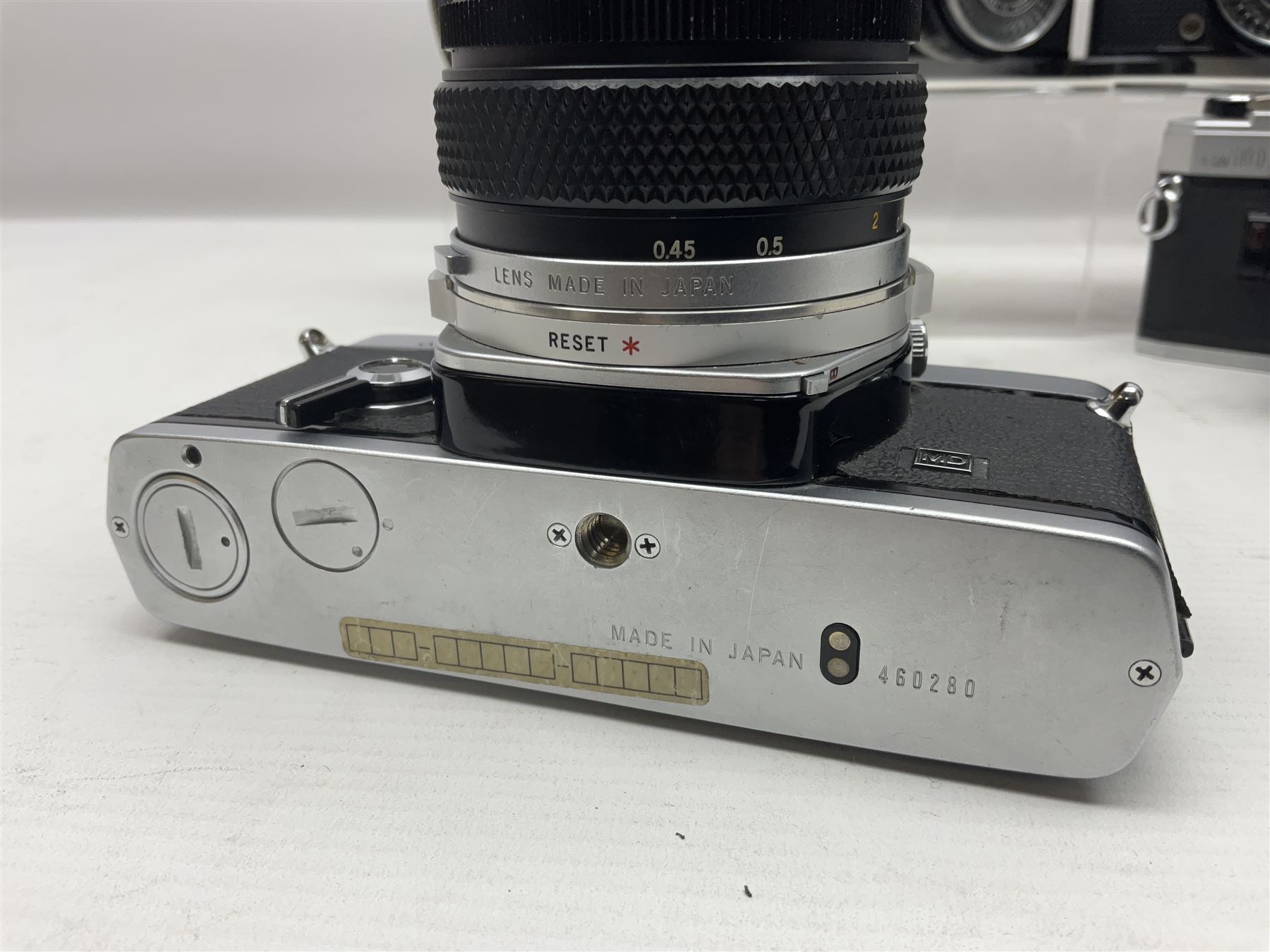 Four Olympus camera bodies, including Olympus OM10, serial no 20744269, with 'Olympus OM-System Zuiko Auto-S 50mm 1:1.8' lens serial no 3633644, Olympus OM-2 camera body serial no 460280 with 'Olympus OM-System G.Zuiko Auto-s 1:1.4 f=50mm' lens, serial no 729750, etc 