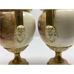 Pair of mid 20th century Royal Worcester vases and covers decorated by Alan Telford, each of ovoid form with twin mask mounted handles, and gilt covers with bud finials, upon a gilt circular pedestal foot and gilt square plinth, the body hand painted with a still life of fruit upon a mossy ground, signed Telford, with black printed mark beneath and painted shape number 2363, H21cm