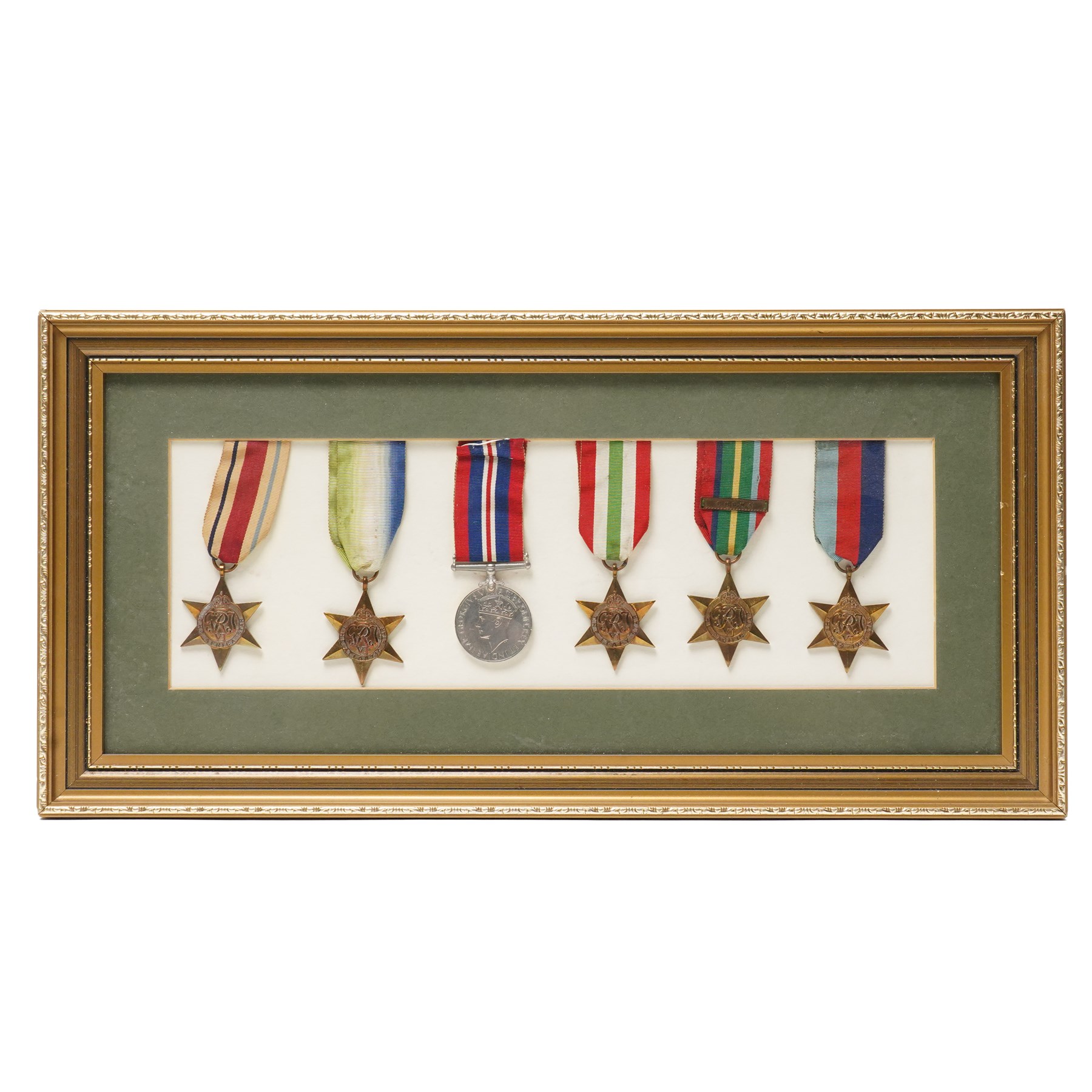 Group of six WWII medals comprising War Medal, 1939-1945 Star, Pacific Star with Burma clasp, Italy Star, Atlantic Star and Africa Star, framed