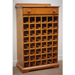  Oregon pine forty eight bottle wine rack, raised back, single drawer, shaped plinth base, W78cm, H127cm, D38cm   