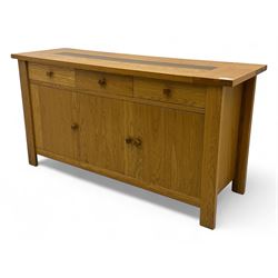 Contemporary oak sideboard, rectangular top with central contrasting plank, over three frieze drawers and three cupboards with enclosed shelving, on rectangular stile supports