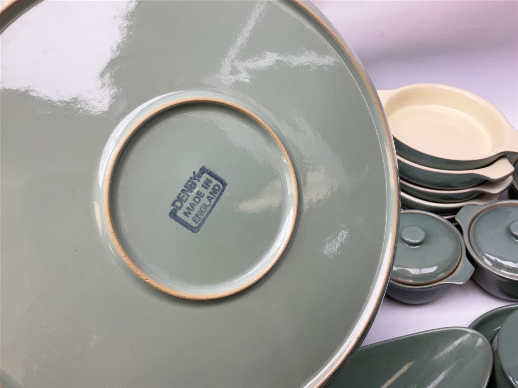 Denby Manor Green pattern part tea and dinner service, to include seven dinner plates, thirteen side plates, ten dessert plates, two oval dishes of various sizes, four cups and saucers, seven bowls with covers, two teapots etc (74)  