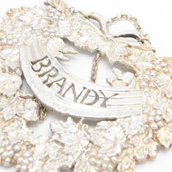 Late 20th century silver decanter label, cast in the form of a wreath of fruiting vines, with pierced 'Brandy' lettering, H7.5cm, W8cm