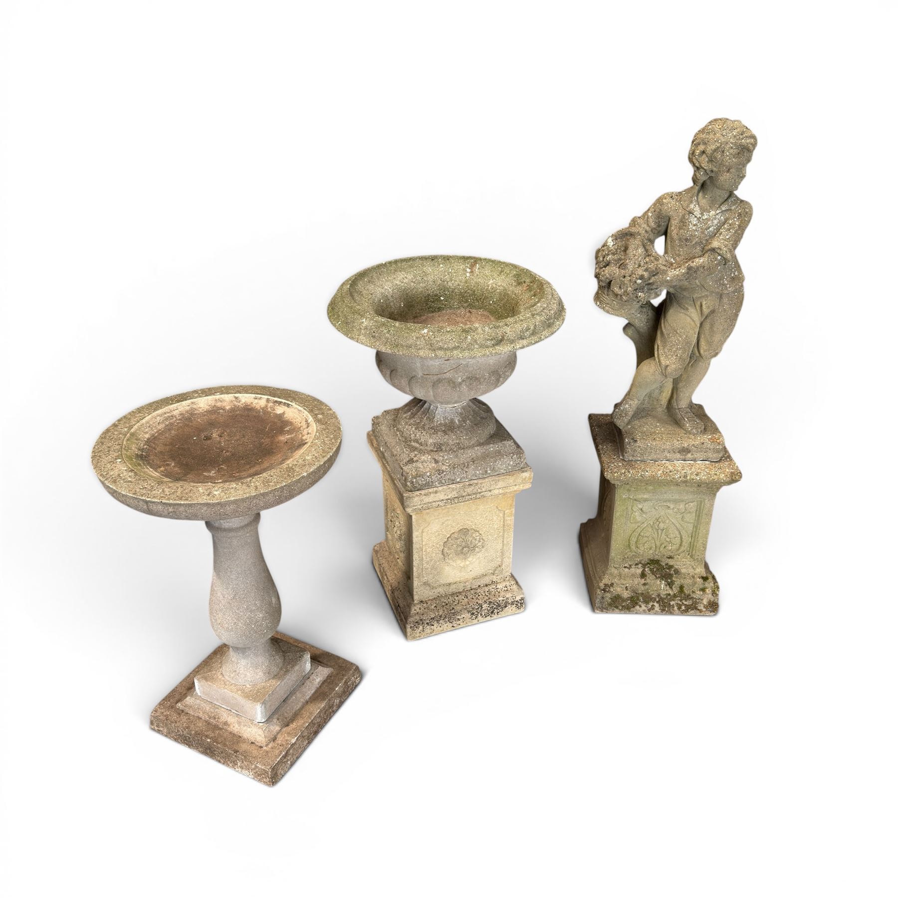 Weathered cast stone statue of a child and urn planter on pedestal along with three piece bird bath