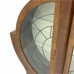 Art Deco walnut moon cabinet, enclosed by two lead glazed doors, three glass shelves