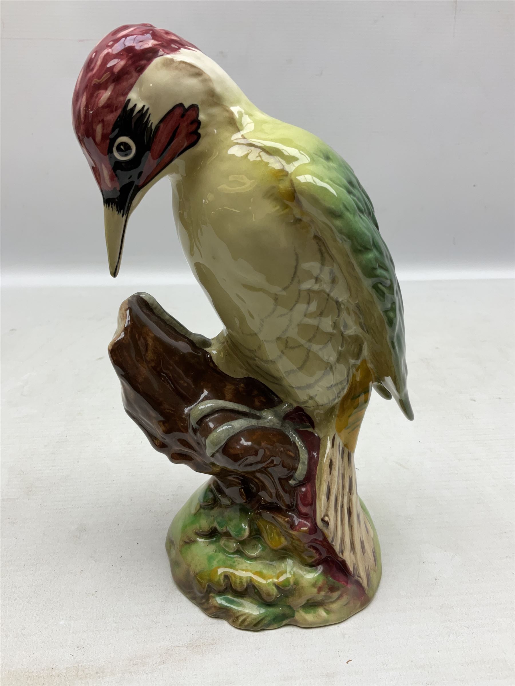 Three Beswick figures of birds, comprising pheasant no 1225, magpie no 2305 and woodpecker 1218, all with impressed marks beneath, tallest H22cm