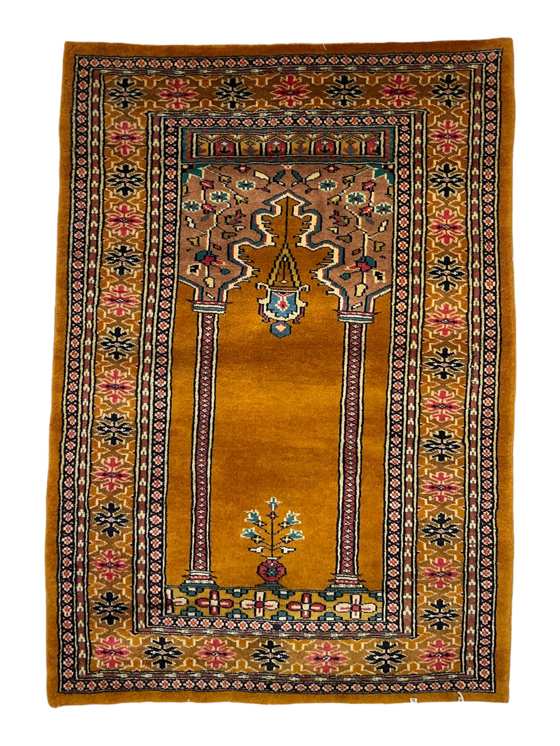 Angle-poise lamp and an Islamic prayer mat