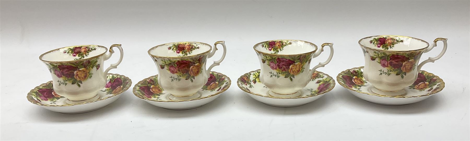 Royal Albert Old Country Roses part dinner and tea service comprising teapot, four tea cups and saucers, eight dessert plates, cake plate, cake stand, a tureen with cover, six dinner plates, an oval dish, two trinket dishes, bell and shoe decoration. 