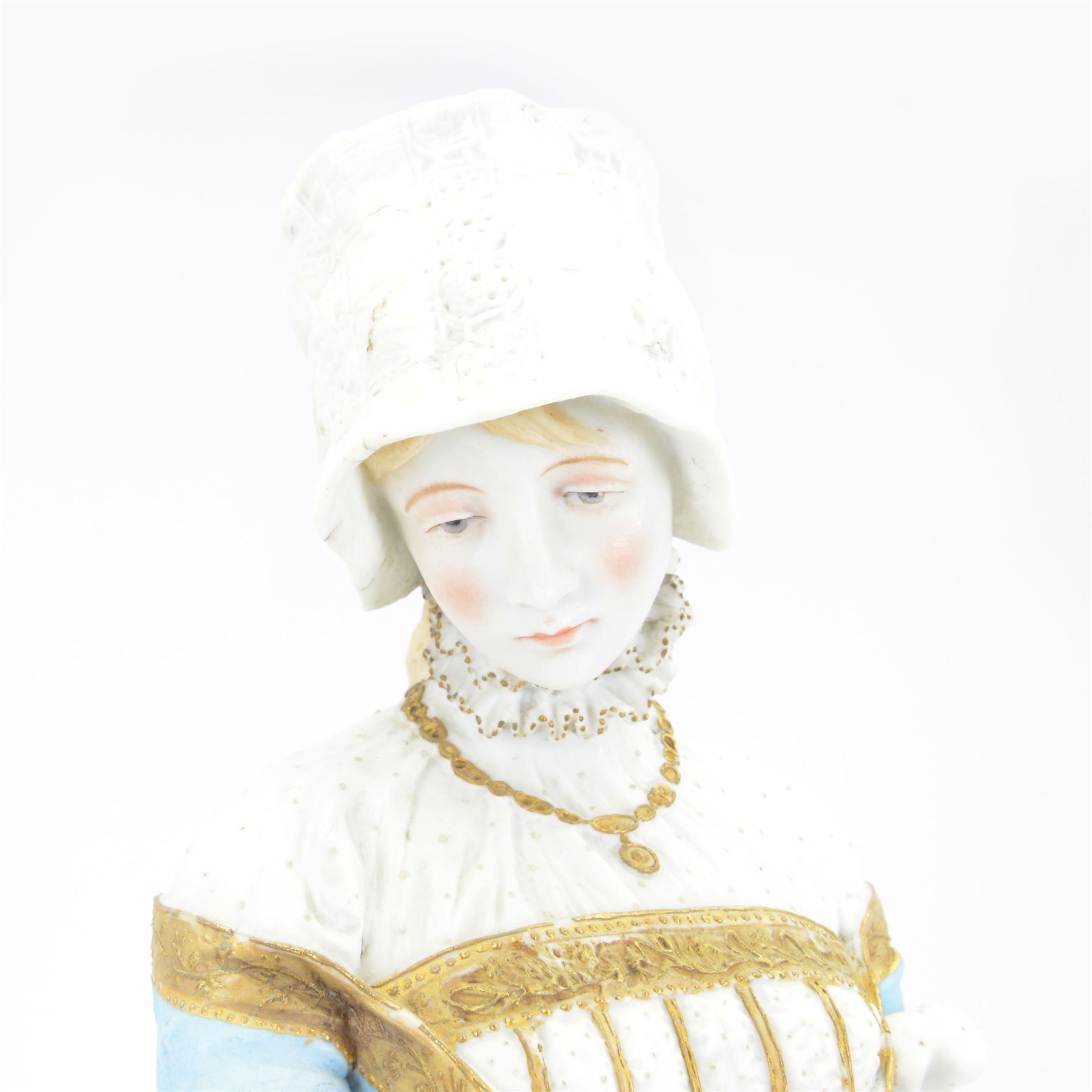 Large late 19th century French bisque figure, in the manner of Jean Gille, modelled as a female figure in high neck floral gown and bonnet, upon a naturalistically detailed circular base, overall H65.5m