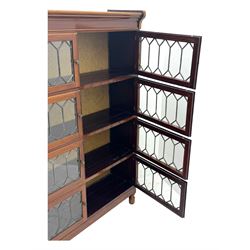 Early 20th century Globe Wernicke design stacking walnut bookcase, fitted with four sections each with two leaded glass doors, raised on turned feet