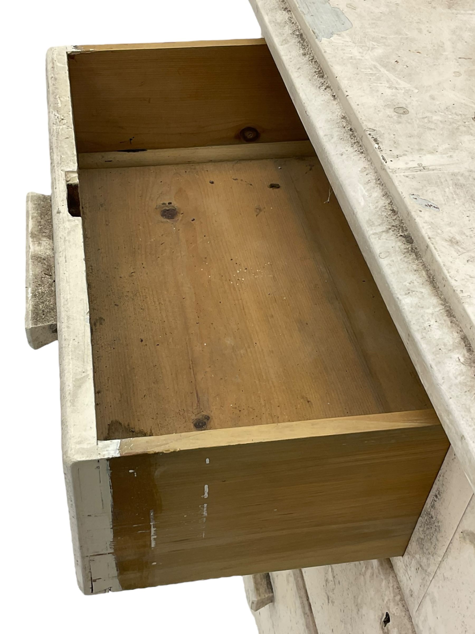 20th century painted pine chest of drawers, rectangular top over two short and two long drawers, scalloped apron, on castors