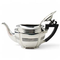 Late Victorian silver three piece tea set of panel sided oval design, the teapot with ebonised handle and lift, Chester 1898/99 Maker Florence Warden and William Aitken