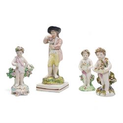 Derby porcelain model of a cherub holding a basket of flowers and wearing a chaplet, H13cm, another Derby cherub holding a basket of flowers and another Derby style cherub, together with a 19th century Staffordshire Ralph Wood type pearlware figure emblematic of Autumn, holding grapes and a goblet (4)