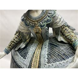 Large Lladro figure, La Menina, modelled as a maid of honor in service, on a mahogany oval base, limited edition 99/1000, sculpted by Jose Puche, with certificate of authenticity, framed and glazed, no 1812, year issued 1996, year retired 2019, H60cm