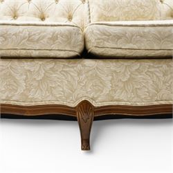 Mahogany framed three seat sofa in the Louis XV style, the shaped buttoned back above loose seat cushions and scrolling arms, raised on cabriole legs with shaped apron