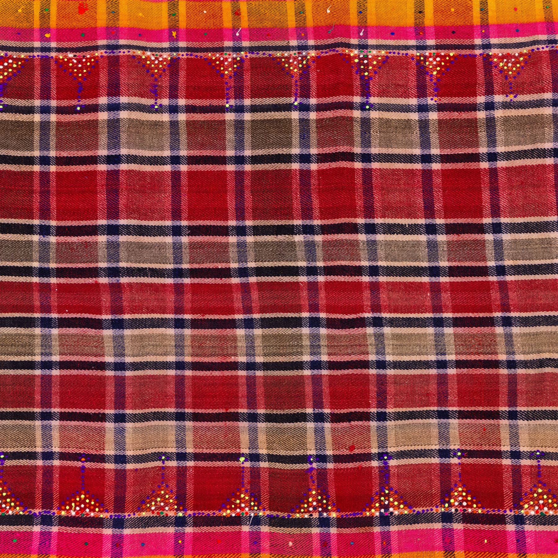 South West Persian Jajim kilim, field woven with a plaid design of intersecting bands in shades of red, terracotta, pink, and ochre, flanked by contrasting side panels decorated with small geometric tribal motifs the decoration incorporating raised wool details against flatwoven ground  