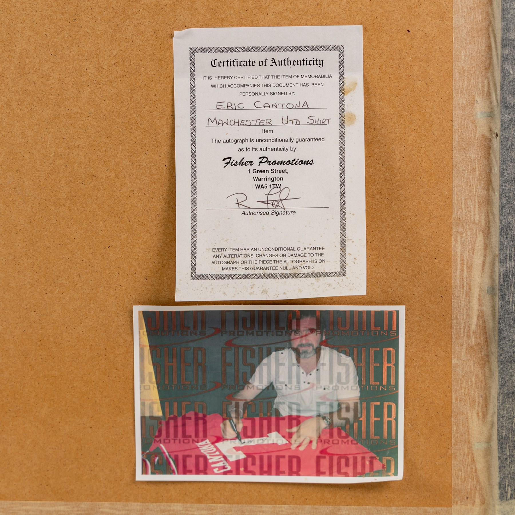 Signed Eric Cantona shirt, framed within a montage of iconic photographs from his Manchester United career, the shirt signed in black marker to the number, with certificate of authenticity from Fisher Promotions, frame H83cm