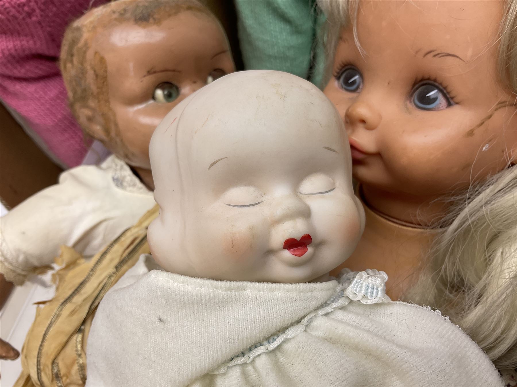 Quantity of vintage and later dolls to include unusual three faced example and further dolls marked C.J, Gloobee, Rosebud etc in three boxes
