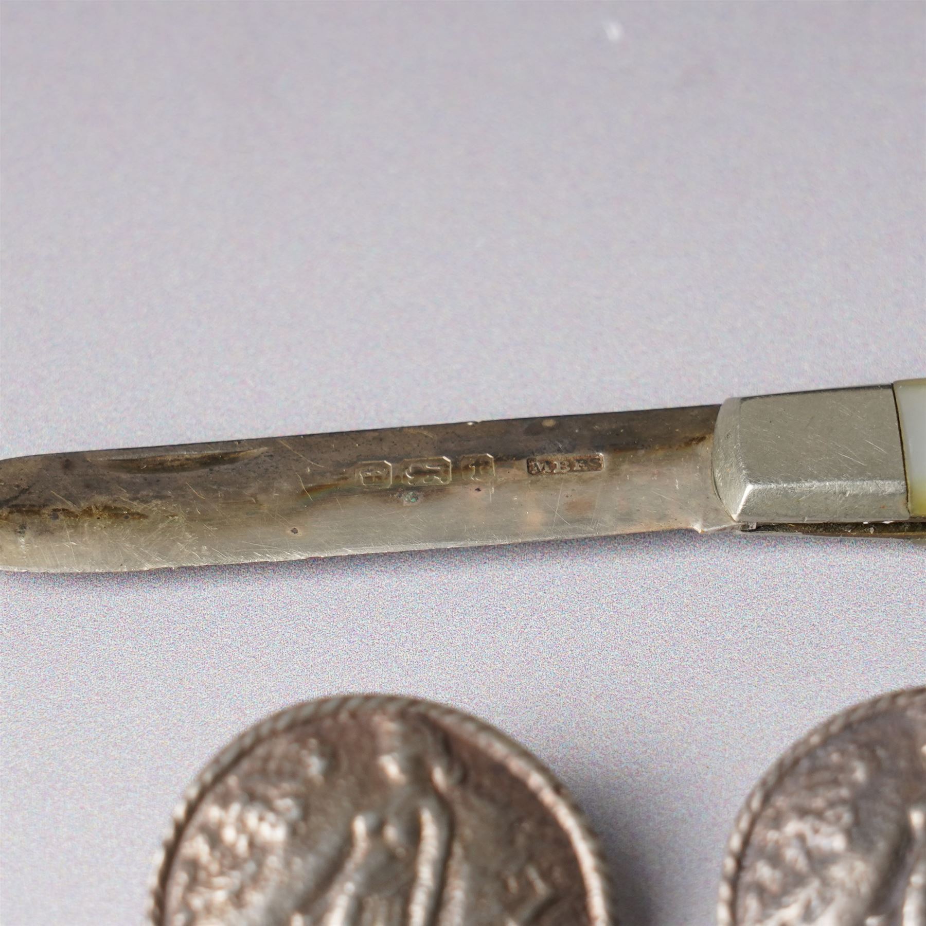 Five late Victorian silver buttons with a raised pattern of a female figure Birmingham 1900 Maker Laurence Emanuel and a silver bladed and mother of pearl fruit knife