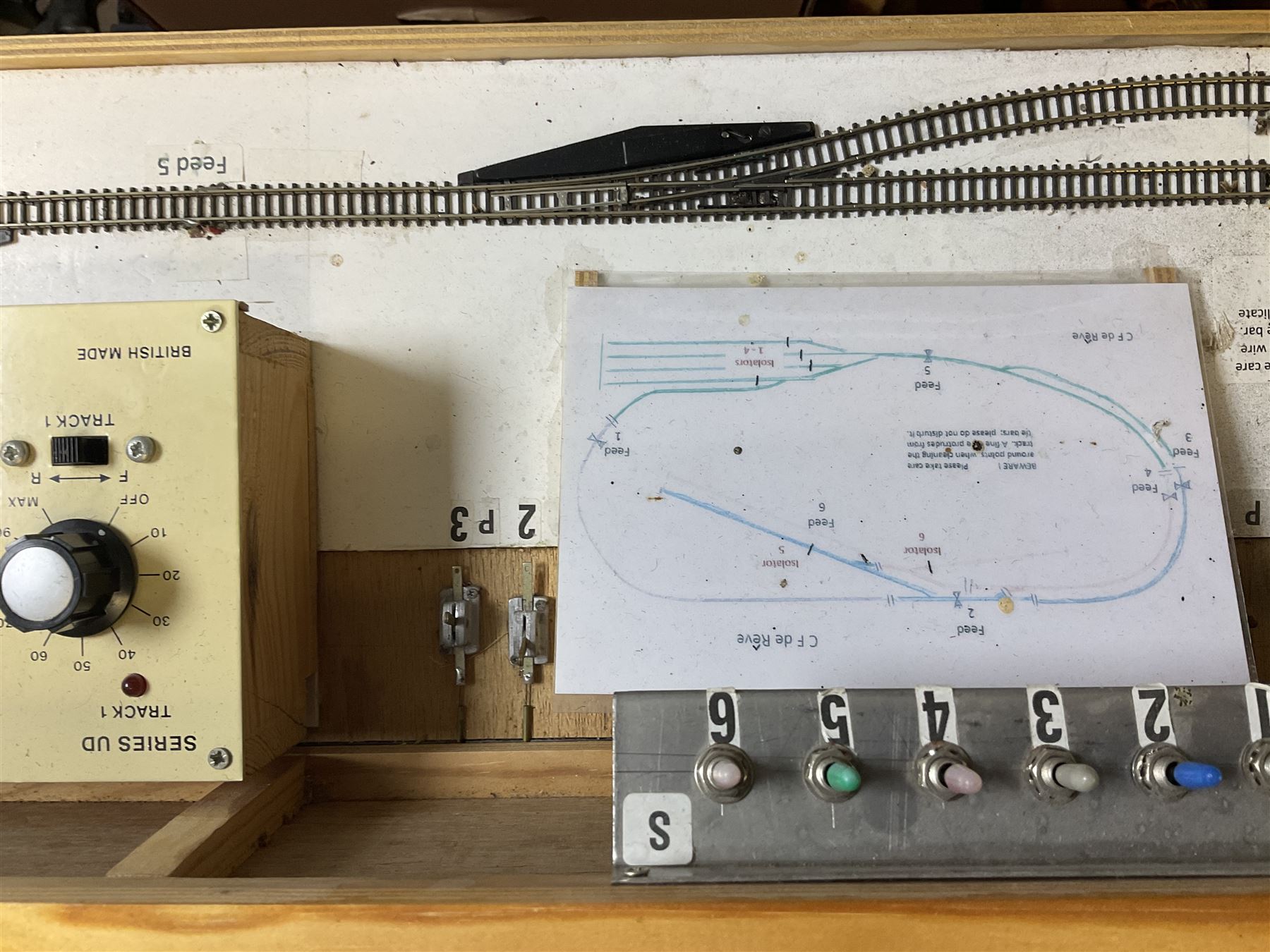 'Z' gauge continental scenic layout with folding legs, various loops of track and sidings with overhead cables, buildings including water tower, tunnels, roads with motor vehicles and figures, trees, haven with boats, backdrop diving wall hiding control units 150 x 50cm