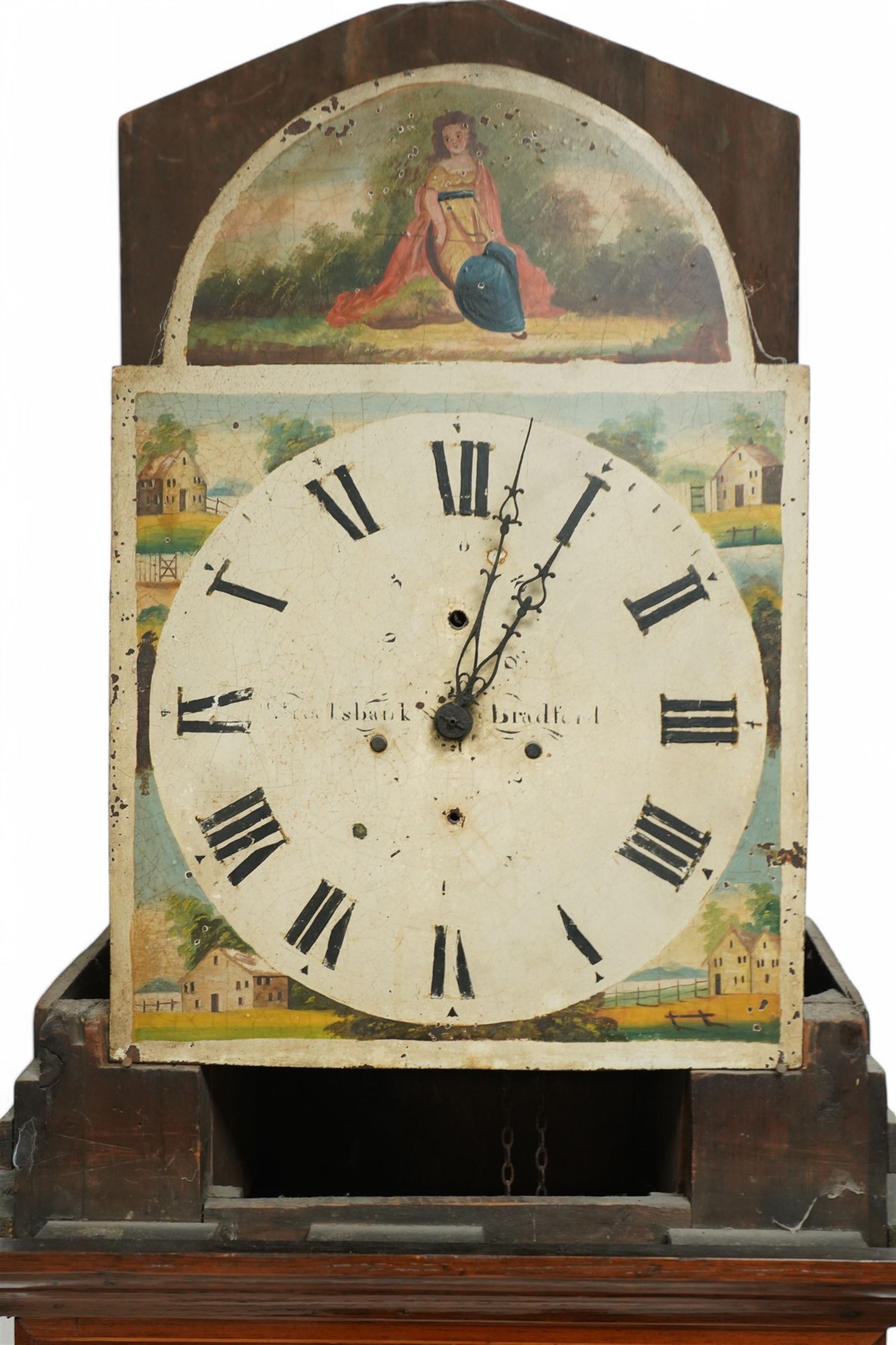 William Brooksbank of Bradford - late oak and mahogany 30-hour 19th century longcase clock c1860, with a swan necked pediment and turned wooden +finial, with a break arch hood door flanked by bobbin turned pilasters, trunk with canted corners and a short trunk door on a broad plinth with banding, painted dial with painted cottages to the spandrels and a depiction of a country girl to the arch, with broad Roman numerals, makers name and stamped brass hands, dial pinned to a chain driven countwheel movement striking the hours on a bell. With weight and pendulum.
William Brooksbank is recorded as working from Market Street, Bradford, 1837-71.