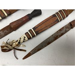 Indian kukri with 29cm curving steel blade and nickel mounted horn grip; in leather covered scabbard with one skinning knife L42cm overall; Hitler Youth knife with scabbard in relic condition; and three African graduated knives each with crudely carved wooden grips and painted leather covered scabbards (5)