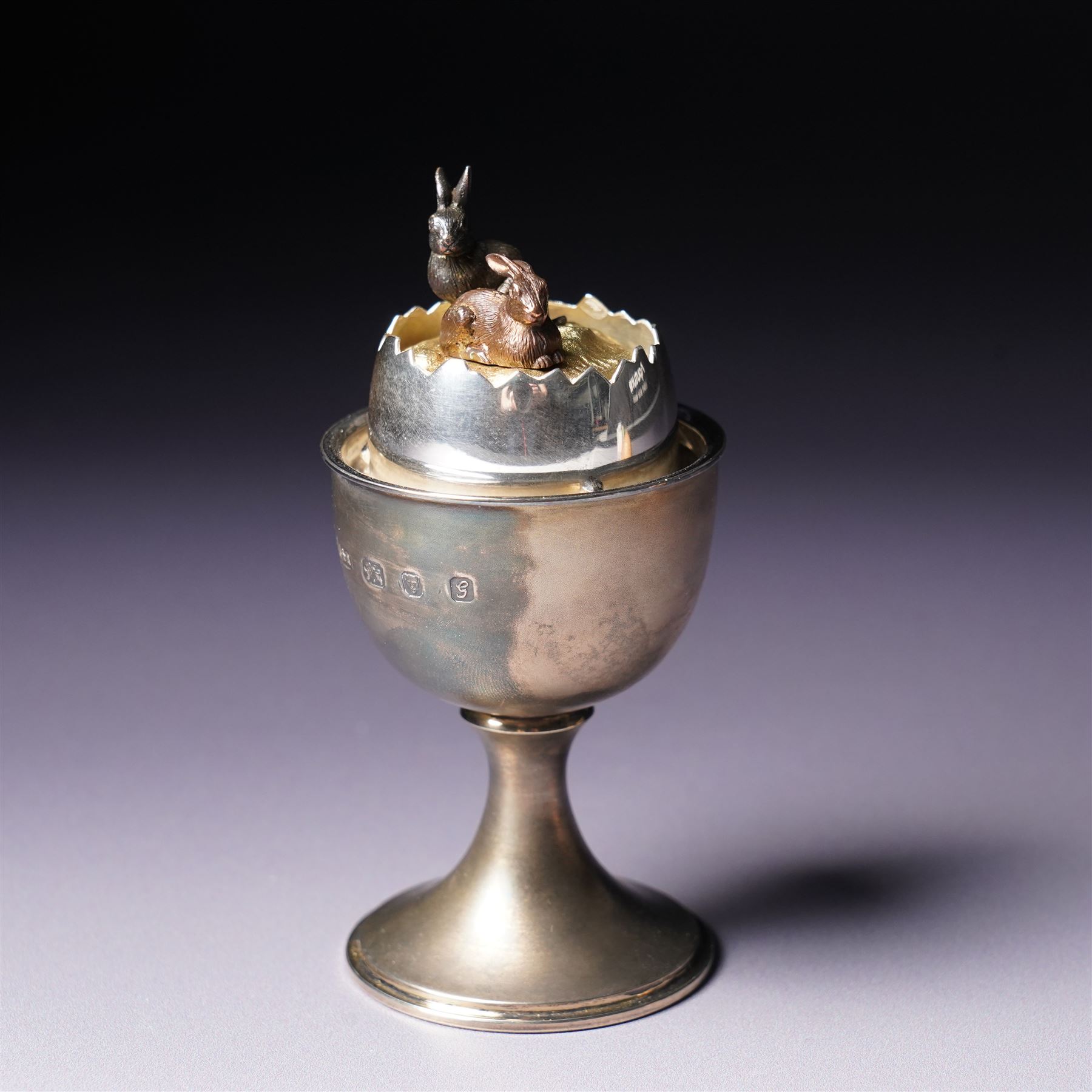 Anthony Gordon Elson -  Elizabeth II limited edition novelty silver and silver gilt surprise egg, the cup holding a gilt lined egg, bayonet opening to reveal two bunnies 4/200  H11cm London 1981
