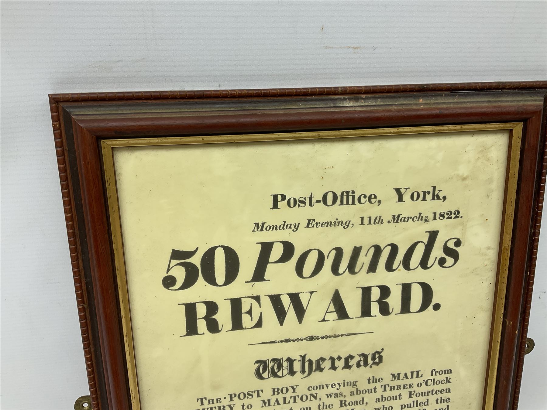 Early 19th century framed local interest York Post Office wanted poster, £50 reward, printed by Henry Cobb dated Monday Evening, 11th March 1822, requesting information about a post boy conveying mail from Whitby to Malton who was pulled from his horse by a thief who stole mail bags for London and York, H44cm