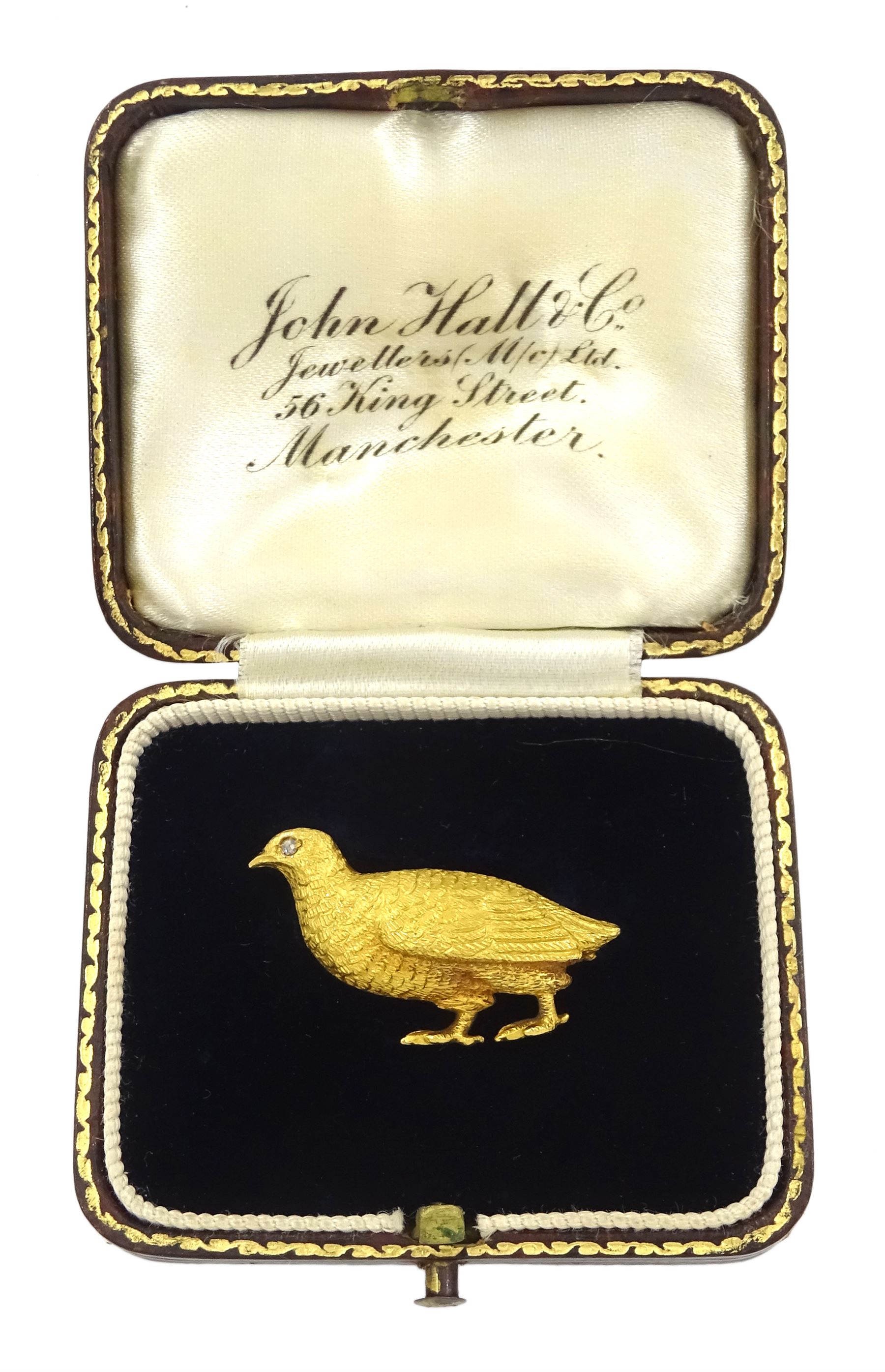 Early 20th century gold grouse brooch, the eye set with a rose cut diamond, stamped 18ct, in fitted silk and velvet lined box by John Hall & Co, Manchester