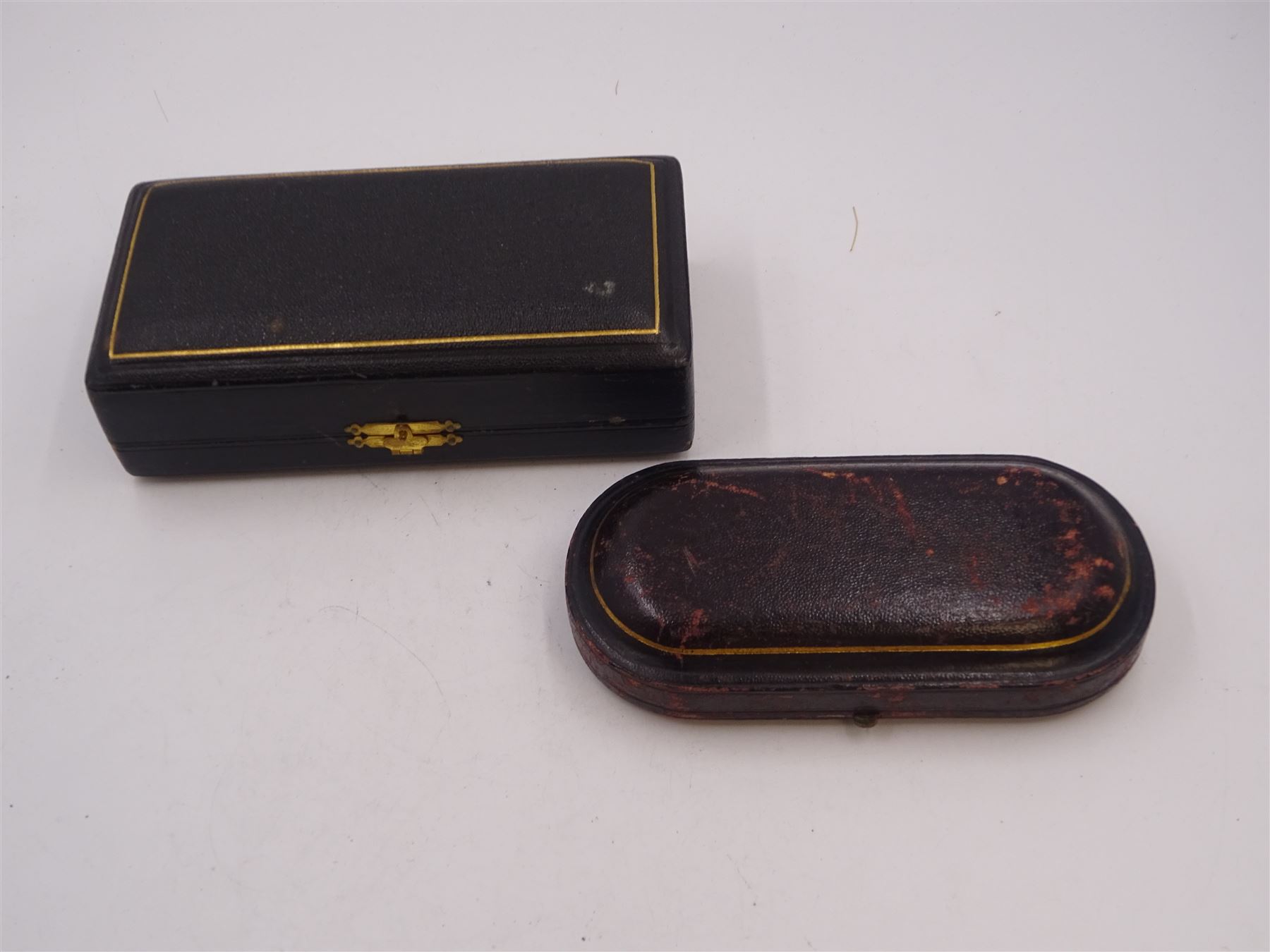 Pair of Victorian silver open salts, of part fluted navette form, with engraved foliate decoration, upon oval stepped foot, hallmarked W H Lyde, Birmingham 1896, H3.5cm, together with a pair of silver salt spoons, with leaf shaped bowls and ball finials, hallmarked Joseph Gloster, Birmingham 1897, together with a pair of Victorian silver open salts, of circular form, with shaped rim and embossed scroll and lattice decoration to the gilded bowl, together with pair of matching silver salt spoons, hallmarked Albert Sydenham, Birmingham 1899, both sets within tooled leather, velvet and silk lined fitted cases