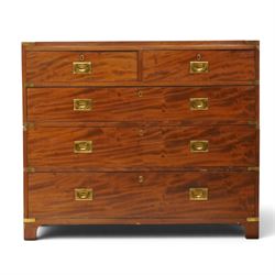 19th century figured mahogany military campaign chest of drawers in two sections, the rectangular top with brass-bound corners over two short and three long graduated drawers, each fitted with recessed brass campaign handles and escutcheons, the carcass with brass strapwork and carrying handles to the sides, raised on short bracket feet