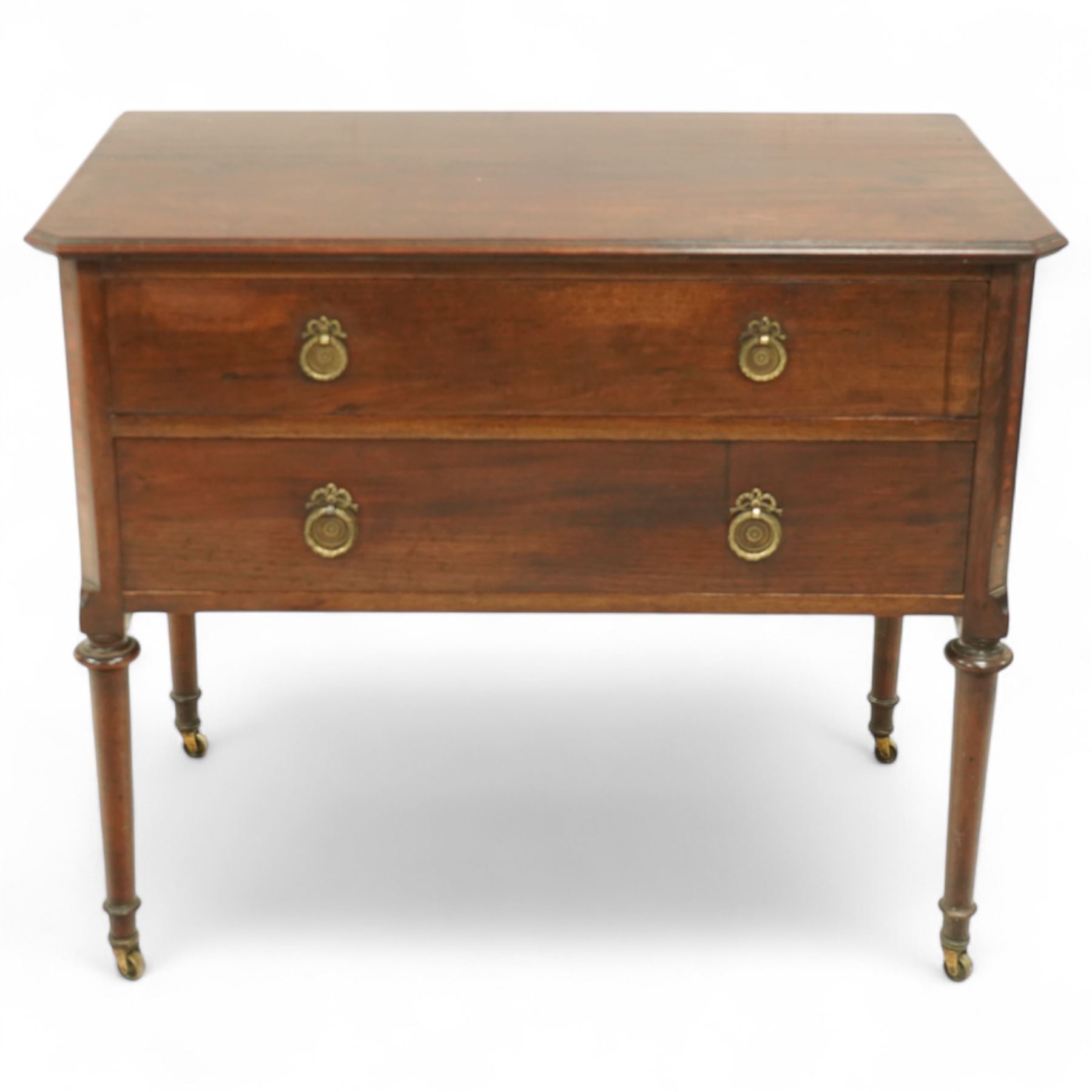 Early 20th century Regency-inspired mahogany two-drawer chest, rectangular top with moulded edge and shaped corners, above two full-width graduated drawers with ring handles, supported on turned tapered legs with brass castors                                                                                                                                                      