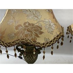 Pair bronzed amphora lamps with pineapple decoration, scroll handles and foliate base with scrolled feet together with pair peach ground shades and raised floral pattern H76cm (2)