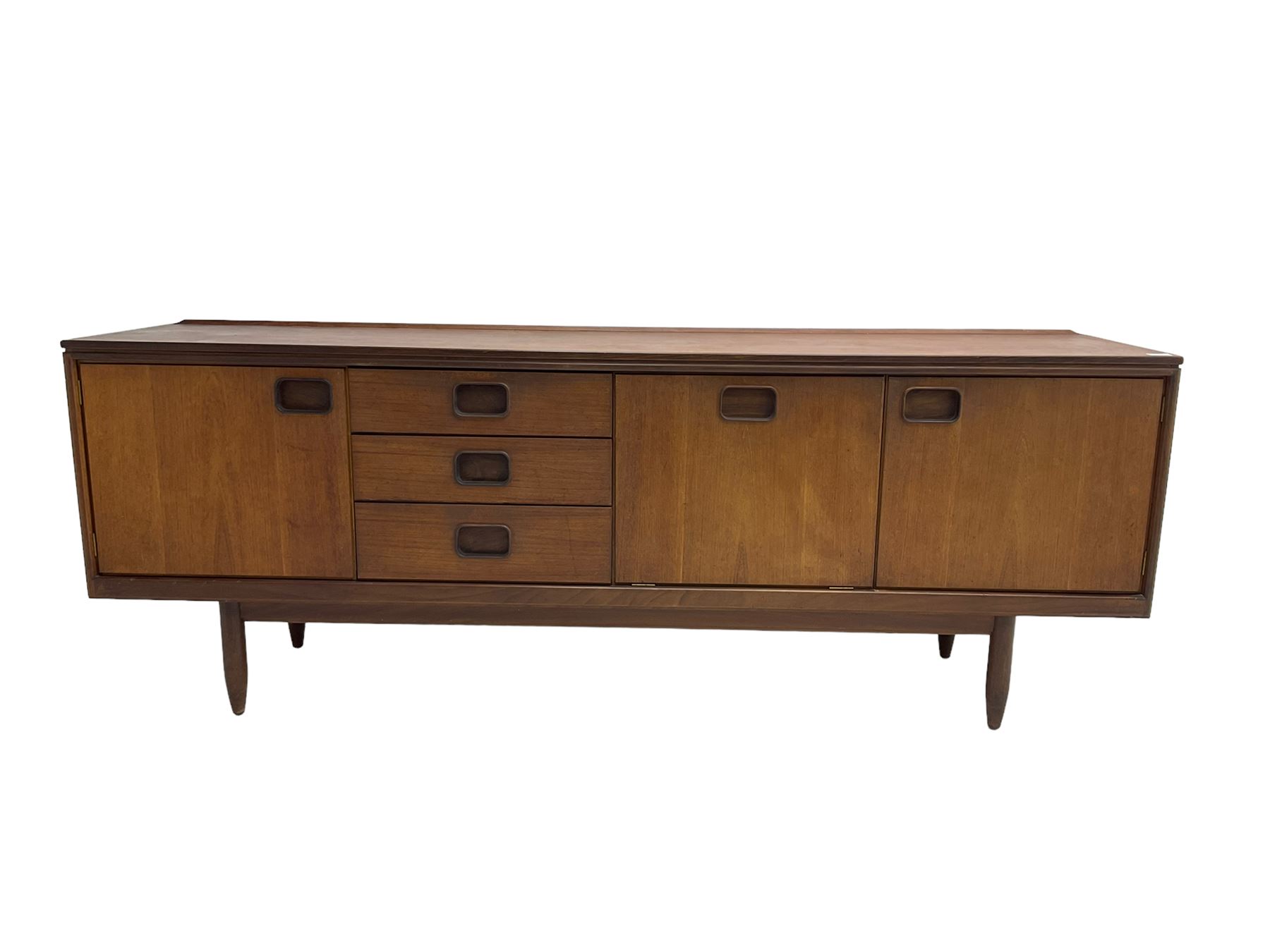 William Lawrence of Nottingham - mid-20th century teak sideboard, with low gallery back over three short drawers and a fall front, flanked by two cupboard doors, enclosing shelves, raised on tapering cylindrical supports, makers mark stamped inside drawer