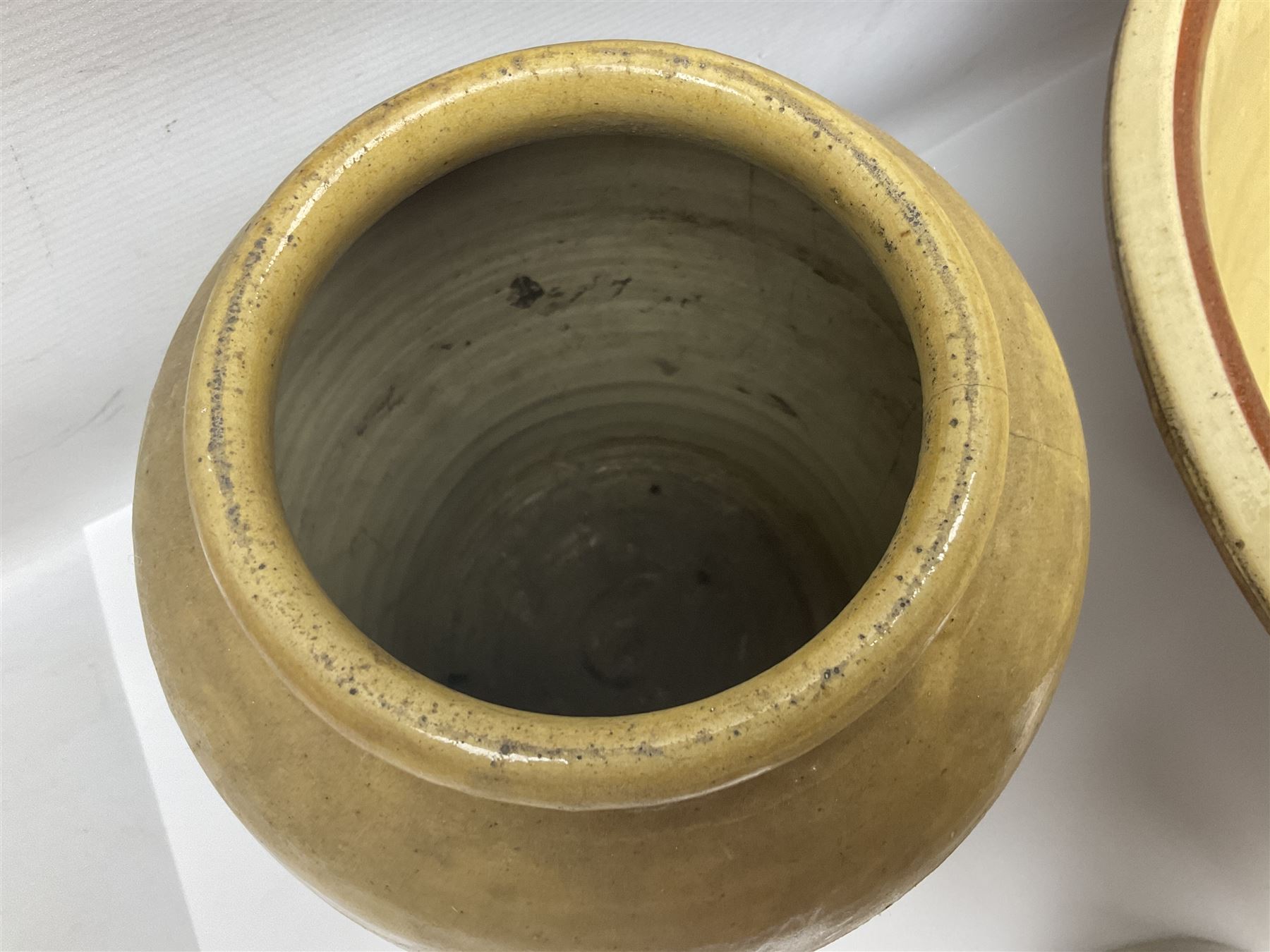 Terracotta bread proving bowl, together with three stoneware jars, tallest H26.5cm