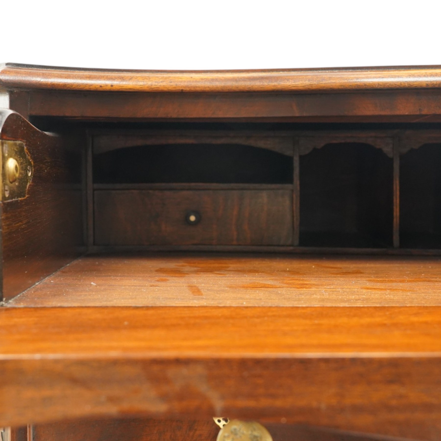 Quality Georgian design mahogany serpentine secretaire chest, the shaped top with moulded edge, fitted with cock-beaded secretaire drawer with button-release fall-front enclosing fitted interior, over three graduating drawers with brass drop handles on pierced circular plates, the canted uprights carved with blind-fret strapwork, lower moulded edge on shaped bracket feet
