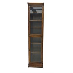 Early 20th century oak library bookcase, enclosed by two glazed doors, fitted with six shelves
