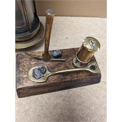Miners lamp, with plaque numbered 173, together with a miniature brass miners lamp and a wooden paperweight with applied brass miners lamp, pick axe and shovel