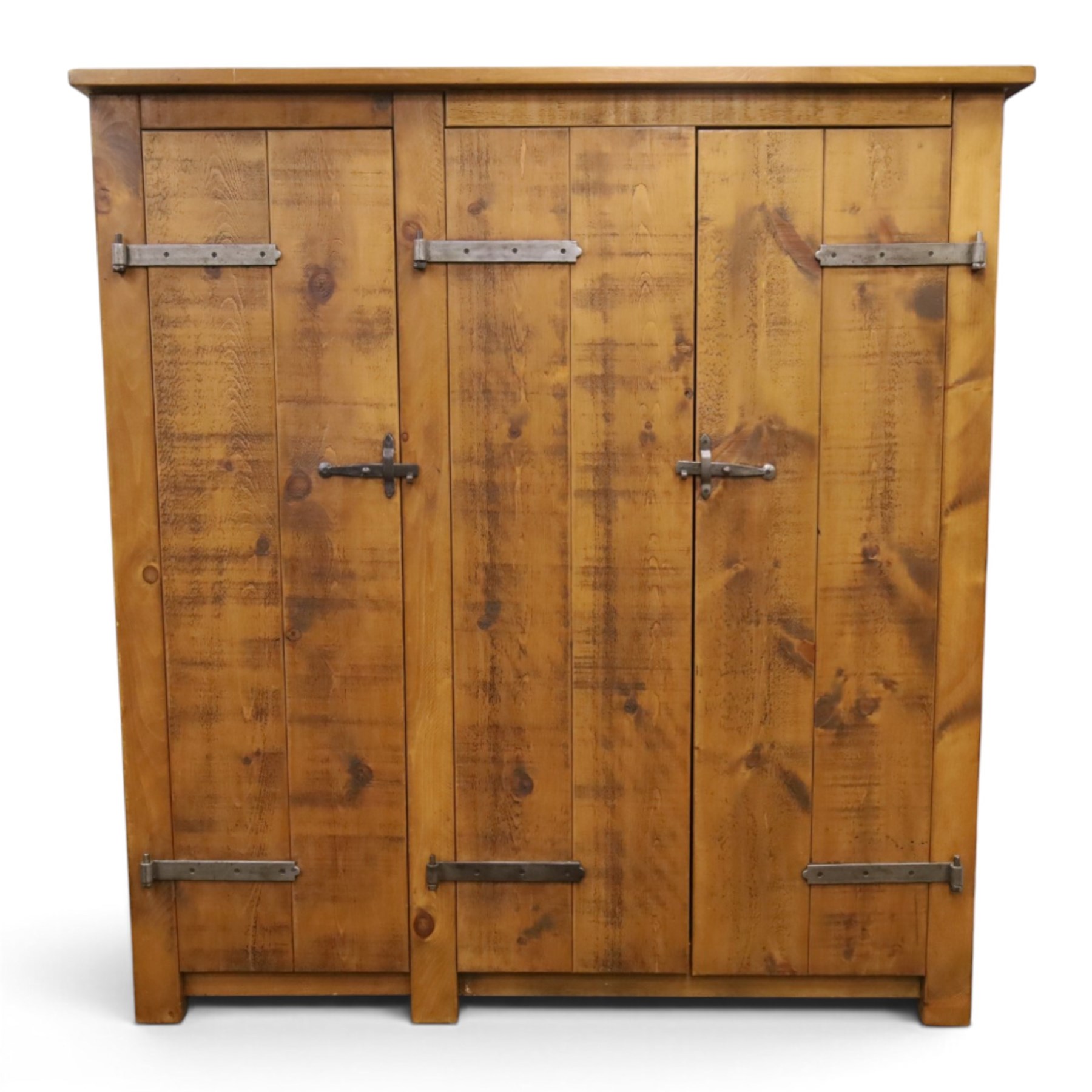 Indigo Furniture - rustic oak triple wardrobe, fitted with three doors with wrought metal fittings and locks, on style supports