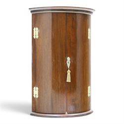 Small Georgian mahogany cylindrical hanging corner cabinet, projecting cornice with dentil carving, brass H hinges and escutcheons