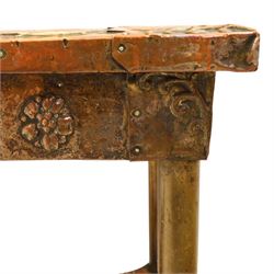 Arts and Crafts copper mounted coffee table, rectangular top with embossed foliate border and stylised corner motifs, studwork detail, on cylindrical supports united by pierced shaped stretcher with applied flowerhead bosses