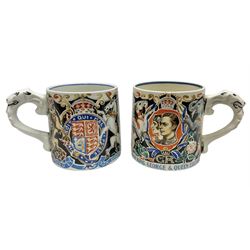 Two Dame Laura Knight coronation mugs for King George VI and Queen Elizabeth, comprising a Burleigh Ware example and a J&G Meakin example, each with a lion moulded handle and printed marks beneath, H8cm