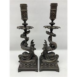 Pair of late 19th/ early 20th century brass candlesticks in the form of dolphins upon a stepped base with Fleur-de-lis design, H32cm 