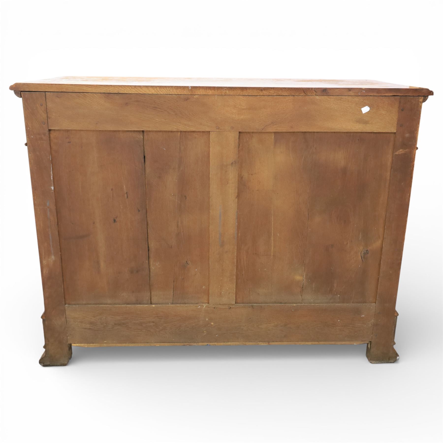 Late 19th century French provincial oak chest of drawers, moulded rectangular top with carved rope edge over four graduated long drawers with raised and fielded panels and ornate cast handles, canted angles and shaped apron below, standing on moulded block feet,