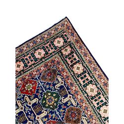 Persian Tabriz indigo ground rug, overall Quba design, decorated with repeating stylised plant motifs and interlaced with trailing leaf motifs, repeating border within geometric guard stripes